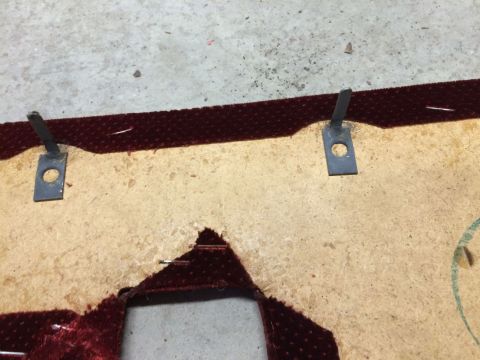 1986 Ford Bronco - Detail of a damaged interior door panel, likely from a disassembled vehicle, showing the backing material and fabric.