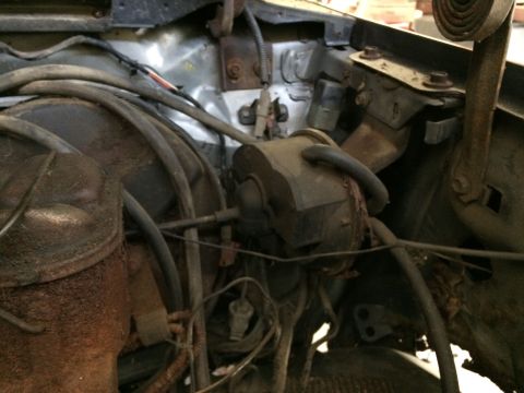 1986 Ford Bronco - Close-up view of engine bay components, showing extensive wiring and some rust.