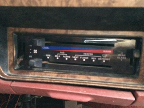 1986 Ford Bronco - Climate control panel showing temperature, fan speed, and air direction settings.