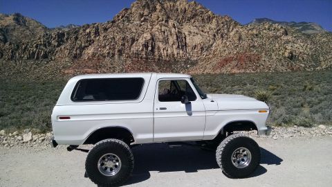 1979 Ford Bronco - This lifted 1979 Ford Bronco is shown in profile against a mountain backdrop.