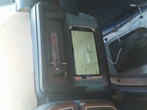 1988 Ford Bronco - Interior view of a vehicle's dashboard, showing a tablet integrated into the center console.