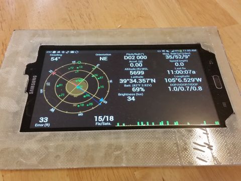1988 Ford Bronco - A Samsung tablet displays detailed GPS information on its screen.