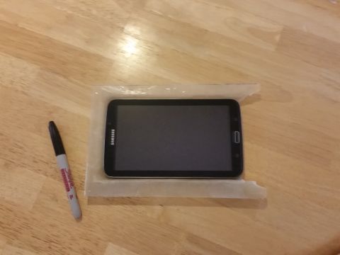 1988 Ford Bronco - A Samsung tablet is placed on a wooden table next to a marker pen.
