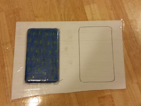 1988 Ford Bronco - A template is drawn on paper next to a blue object with a green pattern.