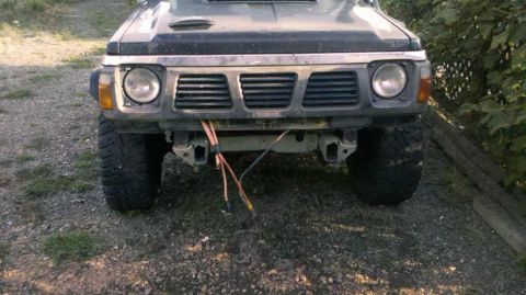 1989 Nissan Patrol - This Nissan Patrol SUV is shown from the front, large off-road tires and a modified bumper.