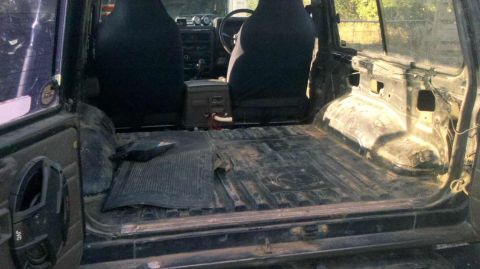 1989 Nissan Patrol - Interior view of a 1989 Nissan Patrol showing a stripped cargo area and front seats.