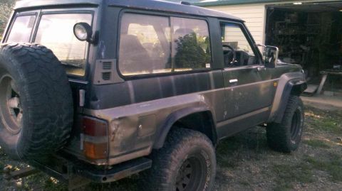 1989 Nissan Patrol - This 1989 Nissan Patrol is shown in a three-quarter front view, a spare tire mounted on the rear door.