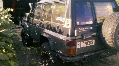 1989 Nissan Patrol - Rear view of a 1989 Nissan Patrol Safari Grandroad SUV, showing the spare tire and license plate.