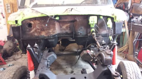 1978 Ford Bronco - The vehicle's front end is disassembled, showing the chassis and suspension components during a restoration project.