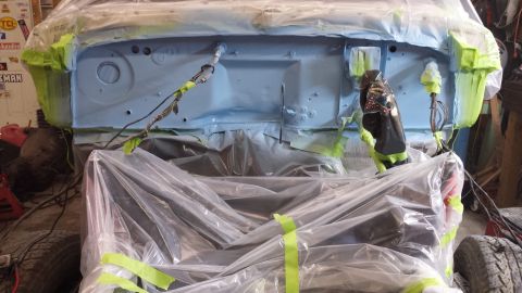1978 Ford Bronco - This vehicle's firewall is being prepped for paint, covered in protective sheeting.