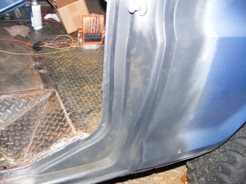 1978 Ford Bronco - Interior view of a vehicle's door sill and floor, showing diamond plate and some tools.