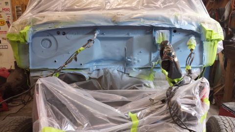1978 Ford Bronco - Firewall of a vehicle being prepared for painting, covered in protective sheeting and tape.