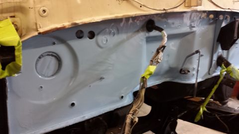 1978 Ford Bronco - The firewall of a vehicle is shown after being painted, with a bundle of wires secured by tape.