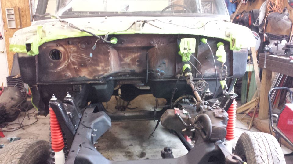 1978 Ford Bronco engine bay with red shocks and exposed engine components