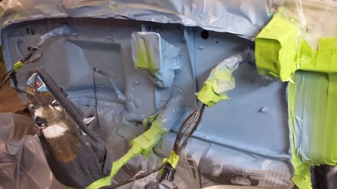 1978 Ford Bronco - Engine bay preparation for painting, with a deer-patterned cloth obscuring some of the wiring.