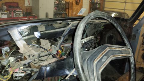 1978 Ford Bronco - The interior of a 1978 Ford Bronco shows a disassembled dashboard and steering wheel, revealing wiring and components.
