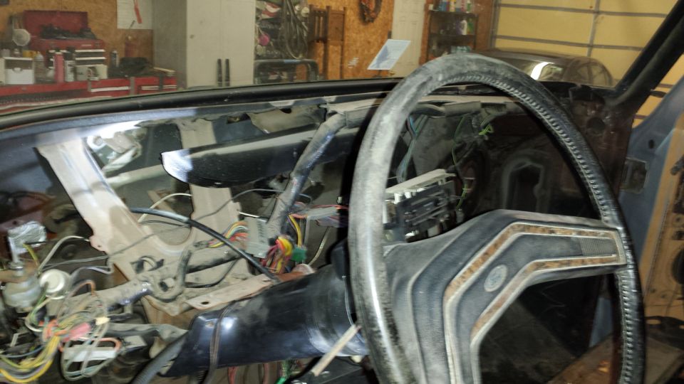 1978 Ford Bronco interior with disassembled dashboard and steering wheel