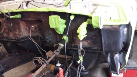 1978 Ford Bronco - Vehicle engine bay being prepped for work, with various components covered in green masking tape.