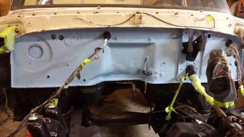 1978 Ford Bronco - The firewall of a 1978 Ford Bronco is visible, painted light blue and partially disassembled.