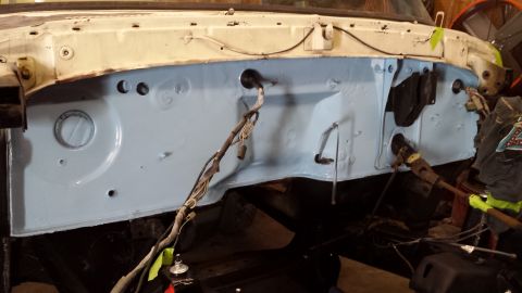 1978 Ford Bronco - The firewall of a vehicle's engine bay, showing exposed wiring and freshly painted metal.