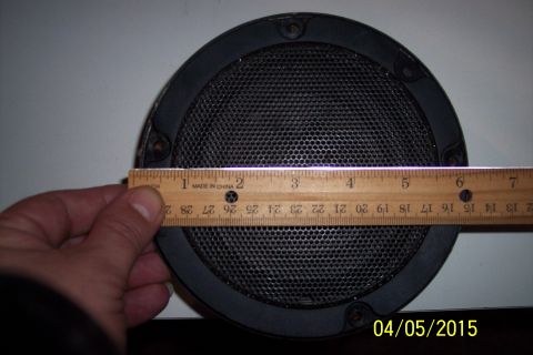 1990 Ford Bronco - A car speaker is measured with a ruler, showing its dimensions.