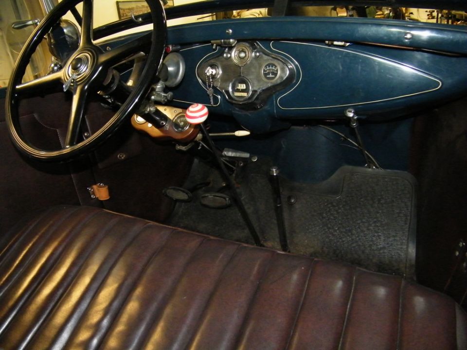 Interior of a 1931 Ford Model A with leather seats and dashboard gauges