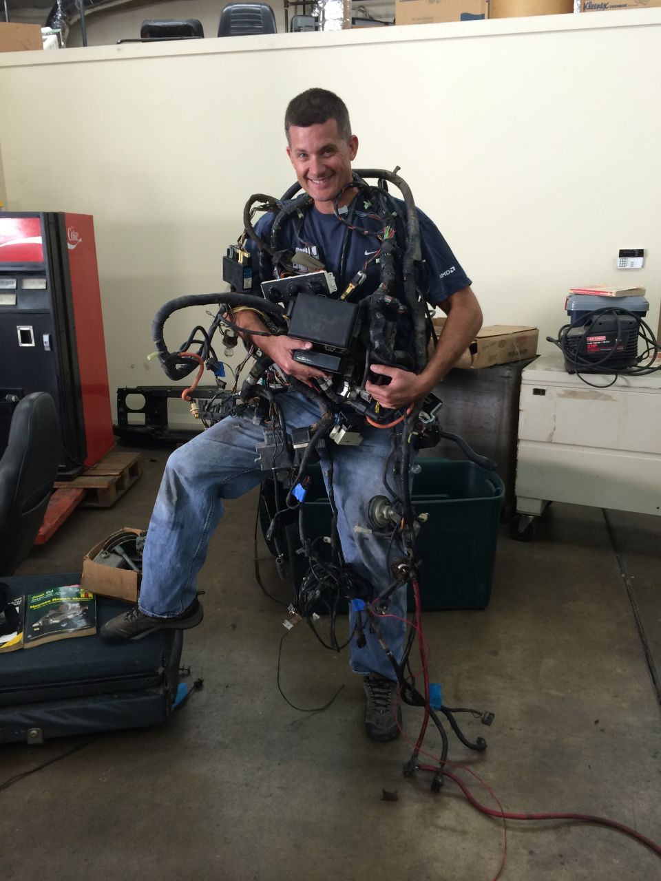 Man wearing a complex vehicle wiring harness