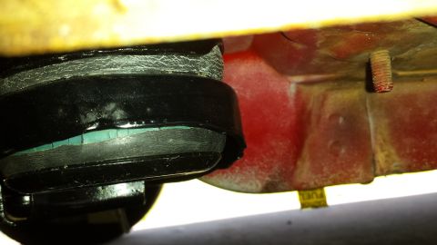 1991 Buick Reatta - Close-up view of a black engine mount with a visible green rubber insert, likely part of a vehicle's suspension system.