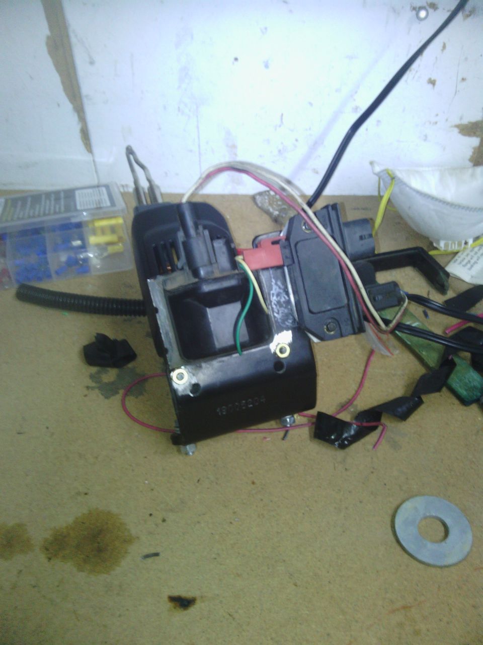 Ignition coil with wires and connectors on a workbench