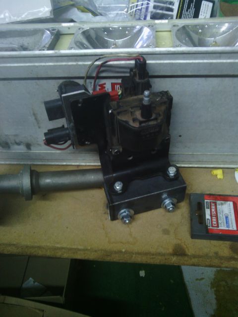 1978 Ford Bronco - A close-up view of a vehicle's distributor assembly, including wiring and a metal mounting bracket.