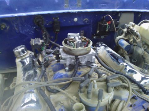 1978 Ford Bronco - Close-up of an engine bay, focusing on the carburetor and associated wiring.