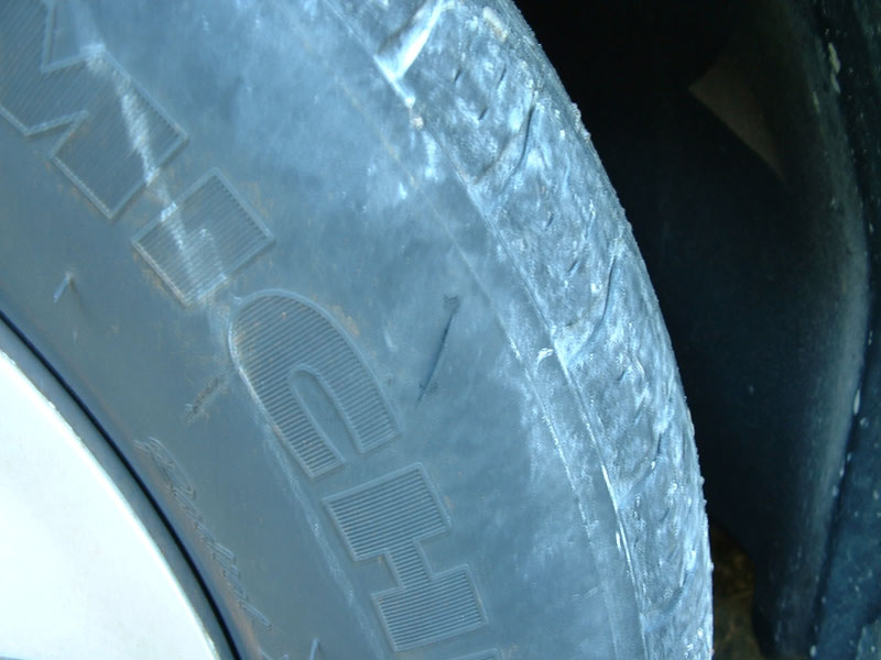 Close-up of Michelin tire sidewall showing scuffs and cracking