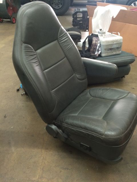 1992 Ford Bronco - A single car seat is shown, detached from a vehicle, with a toolbox and bag in the background.