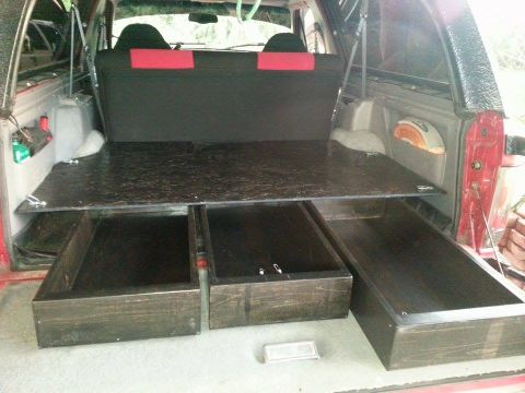 1995 Ford Bronco - Custom wooden drawers installed in the cargo area of a vehicle, with a flat platform above.