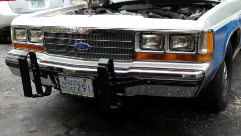 1991 Ford LTD Crown Victoria - Front view of a white police car, possibly a Ford Crown Victoria, equipped with a push bumper and a Massachusetts license plate.