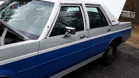 1991 Ford LTD Crown Victoria - This 1991 Ford Crown Victoria sedan is shown with its hood and trunk open, revealing its two-tone silver and blue paint scheme.