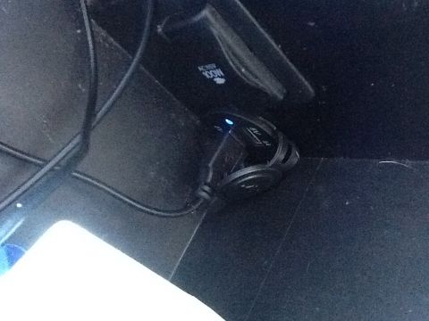 2005 Toyota 4Runner - Close-up of a vehicle's interior showing a power outlet with a USB adapter and an AC inverter.