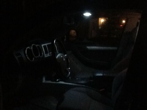 2005 Toyota 4Runner - The dimly lit interior of a vehicle is captured, focusing on the dashboard and steering wheel area.