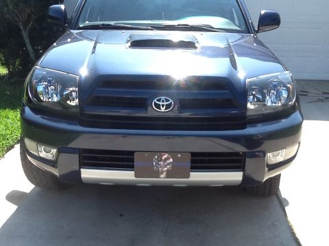 2005 Toyota 4Runner - Front view of a dark blue 2005 Toyota 4Runner, a hood scoop and distinctive grille.