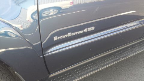 2005 Toyota 4Runner - Side view of a dark SUV with 'Sport Edition 4WD' badging and running boards.