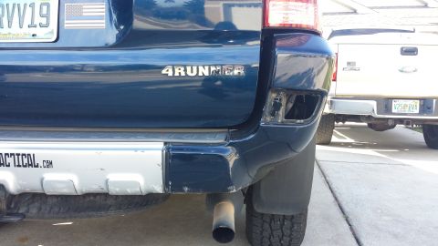 2005 Toyota 4Runner - Rear view of a blue 4Runner showing damage to the bumper and a tactical.com sticker.