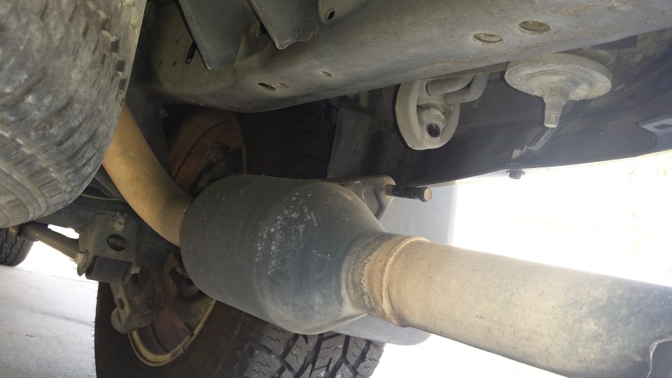 Underbody view of vehicle exhaust pipe, catalytic converter and rear axle