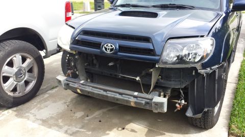 2005 Toyota 4Runner - Front view of a dark blue SUV with its bumper and grille removed, revealing internal components.
