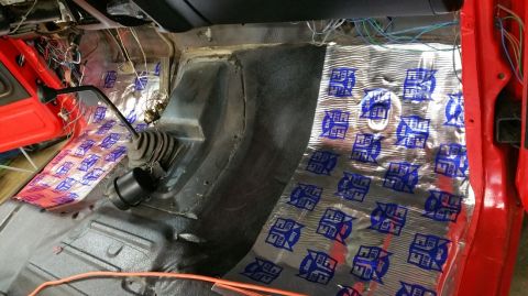 1983 Ford Bronco - Soundproofing material and wiring are visible on the interior floor of a vehicle.