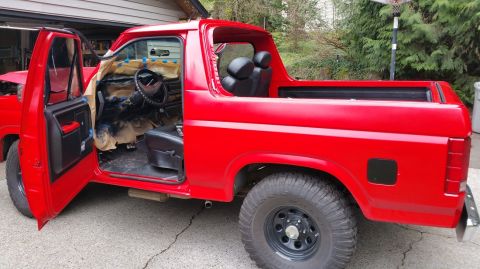 1983 Ford Bronco - This red Ford Bronco appears to be in the process of being repainted or restored.