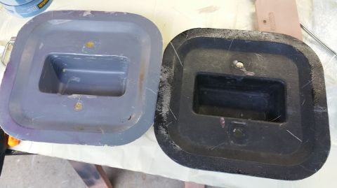 1983 Ford Bronco - Two plastic car parts, one gray and one black, are shown up close.