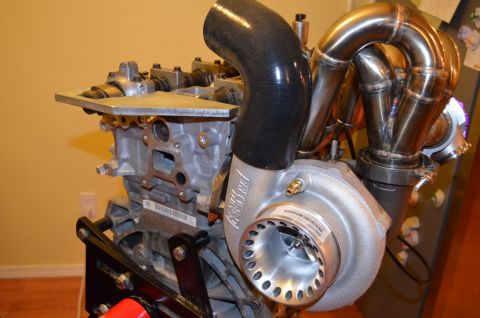 2007 Mazda 6 - Close-up of a turbocharger and exhaust manifold assembly mounted on an engine block.