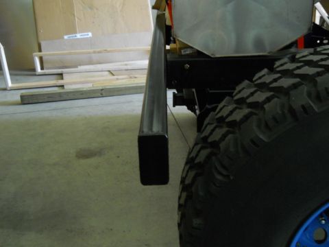 1992 Ford Bronco - Detail of a vehicle's chassis and tire, likely undergoing modification or repair.