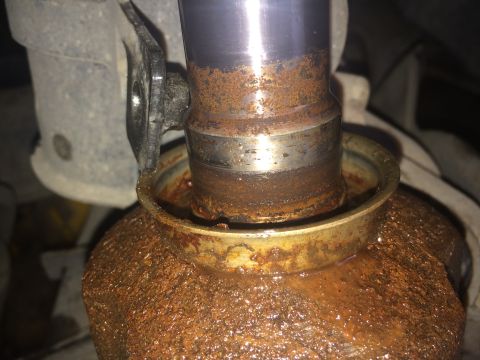 2011 Ford Elite - Close-up view of a heavily rusted CV shaft and seal, with the Supermotors.net logo visible in the lower right corner.