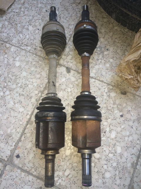 2011 Ford Elite - Comparison of two CV axles, one showing more rust and wear than the other.